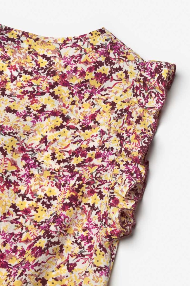 Jumpsuit Yogagi mit rosa und gelbem Blumenmuster.